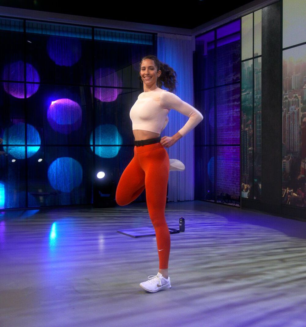 Belen video presenter doing leg raises in the video studio
