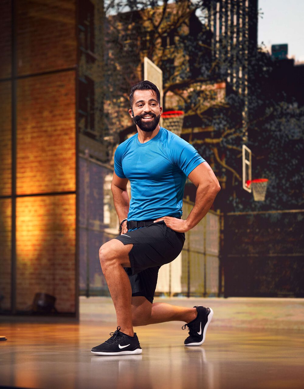 Video presenter Mohamed doing front lunges in the studio